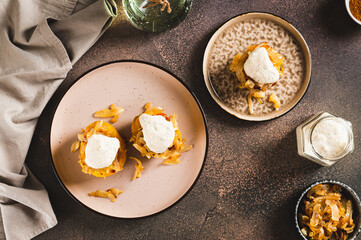 Baked potato with fried onions and ranch dressing on a plate on the table top view
