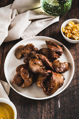 Homemade stewed chicken liver on a plate on the table vertical view