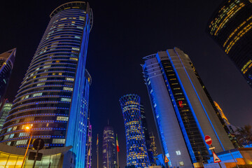 Doha city business downtown center illuminated at night, with modern skyscrapers, Qatar