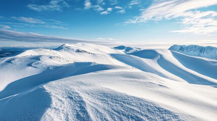 Snow-covered hills under a clear blue sky in winter landscape showcasing natural beauty and serene atmosphere