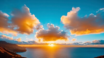 Fototapeta premium Golden sunset over a calm ocean, viewed from a coastal vantage point. Fluffy clouds are illuminated with warm hues, casting a radiant glow on the