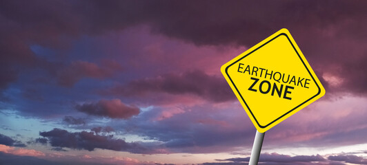 Caution Earthquake Zone Sign on Cracked Rock Background