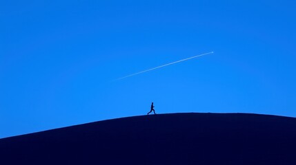 Runner silhouette against a vibrant night sky, dynamic shooting star trail, expansive backdrop, emphasizing motion and inspiration in a celestial setting