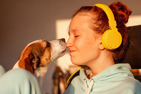 Young woman kissing her good friend dog