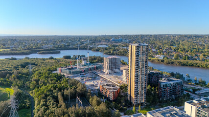 Obraz premium Aerial drone view above western Sydney of Rhodes and Wentworth point with views of buildings and Sydney Harbour NSW Australia 