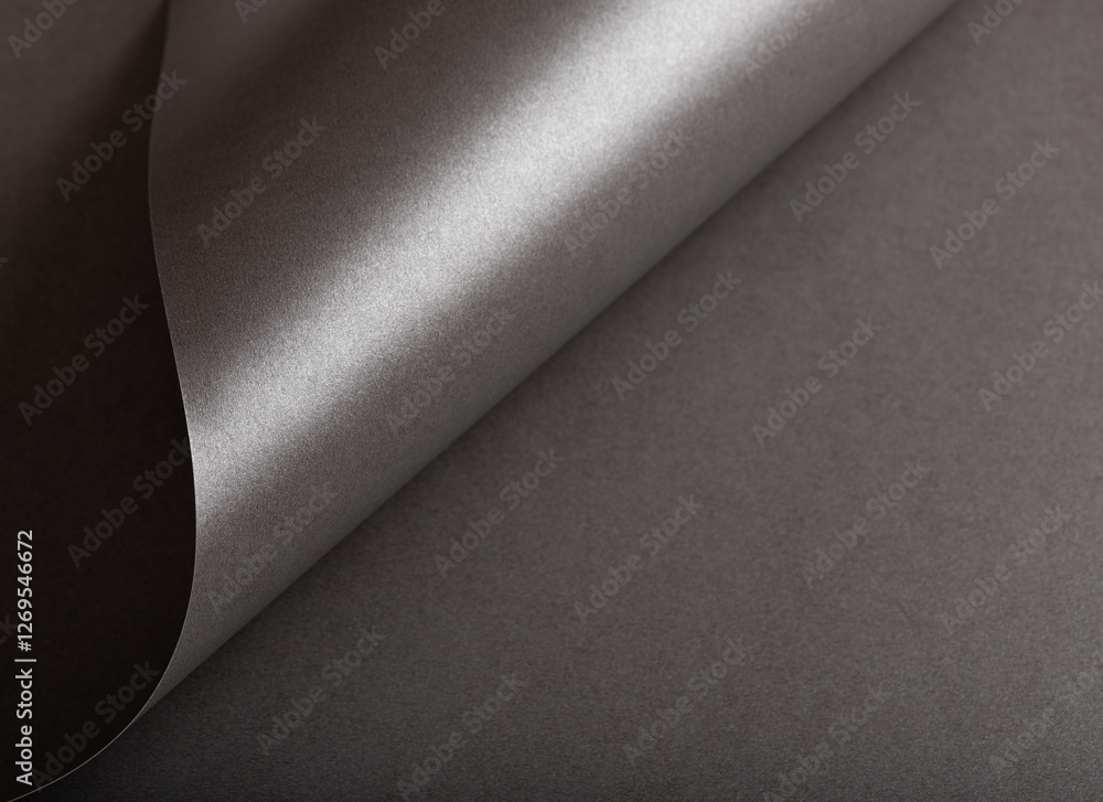 Poster charcoal gray paper background with a pearlescent, glossy texture and shimmering wavy edges. deep gr