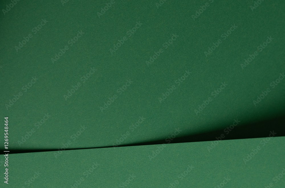 Aufkleber Deep emerald green paper background with a smooth texture and elegant folds. Rich forest and pine tones create a refined, minimal, and artistic abstract design with subtle geometric lines and shadows.
