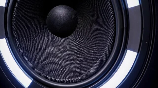close-up moving sub-woofer music speakers vibrating membrane white strobe pulsing light