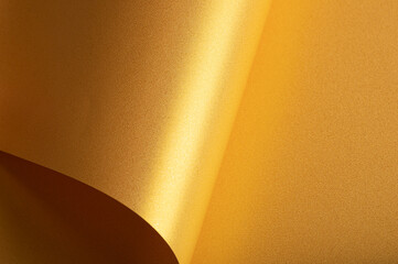 Golden saffron paper background with a pearlescent, glossy texture and shimmering edges. Radiant...