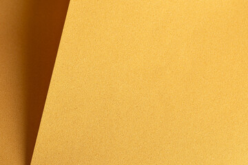 Golden saffron paper background with deep mustard and ochre tones. Smooth, layered textures and...