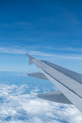 Obraz premium Sky and cloud seen through the window of airplane, with the plane wing