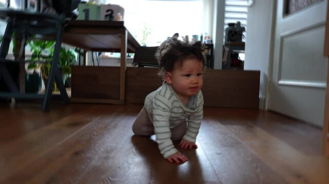 Baby boy crawling on the floor towards the camera. Baby development concept.