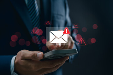 Concept of spam email alert and cyber attack danger. Businessman using smartphone receiving email...