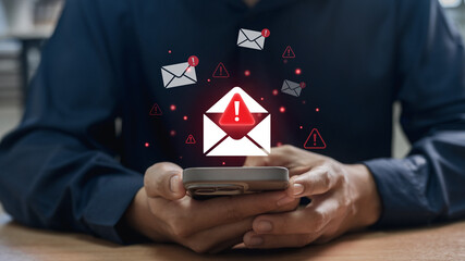 Phishing scam and spam email warning concept. office worker checks mobile phone, symbolizing cybersecurity attack threat, alert message and digital safety challenge