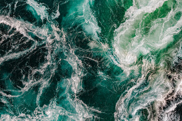 Blue waves of water of the river and the sea meet each other during high tide and low tide.