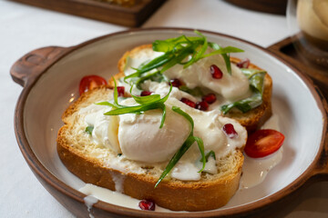 Brioche with poached egg for breakfast