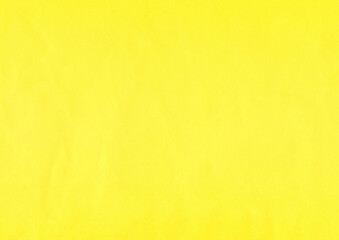 Yellow, contrasting surface of an old paper or cardboard, background, texture. Backdrop of aged,...