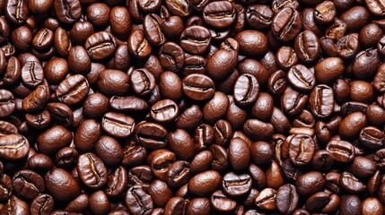 A high-resolution close-up of rich, aromatic coffee beans, showcasing their deep brown color and glossy texture. Perfect for coffee lovers and enthusiasts, this image highlights the essence of freshly
