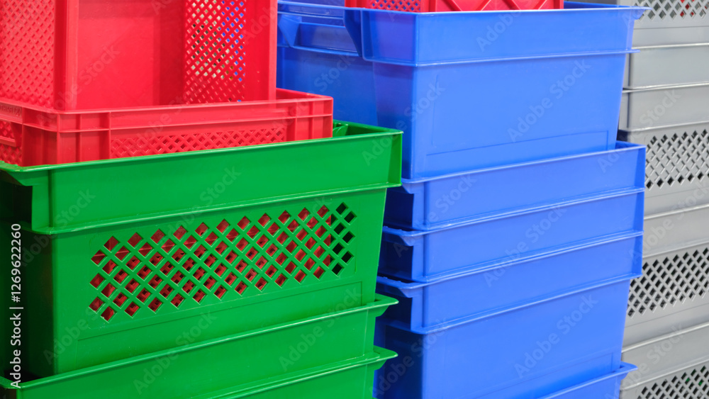 Aufkleber a stack of plastic containers in various colors, including green, blue, and red. the containers are 
