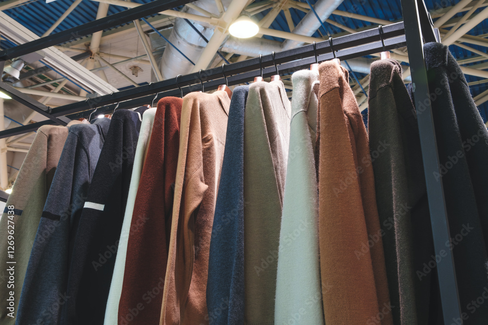 Fototapete a rack of clothes with a variety of colors and styles. the clothes are hanging on a rack, and the ra
