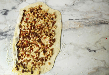 Wraps a layer of yeast dough filled with apple, raisins in a roll. Space for copyspace text