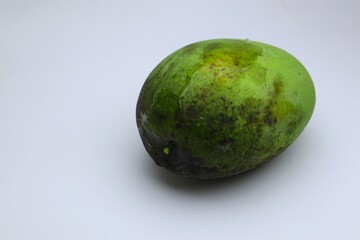 A Close-Up of an Unripe Mango Exhibiting Natural Imperfections