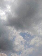 Dramatic Sky with Dark Gray Clouds and Patches of Blue Sky Peeking Through