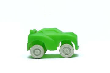 Close-up of a green toy car on a white background for kids playing