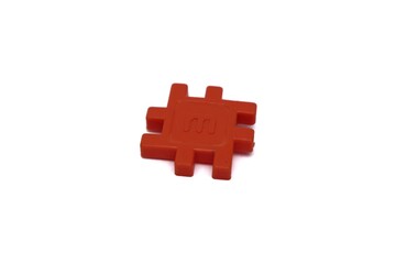 A single orange Interstar interlocking plastic block toy on white background