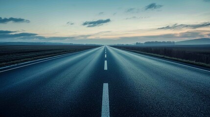 Fototapeta premium Deserted Highway with Dark Freshly Laid Asphalt at Dusk
