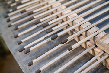 Candle sticks being crafted in a vibrant Bengal candle factory showcasing skilled craftsmanship and...