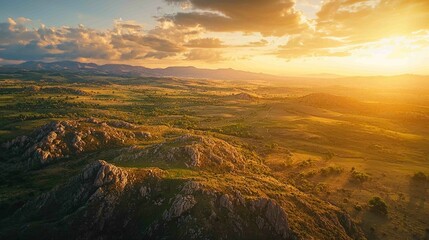 Obraz premium Dramatic Aerial View of Diverse Land Types at Sunset Horizon