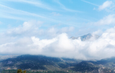 Cumulus Congestus Clouds against blue sky over  montains.