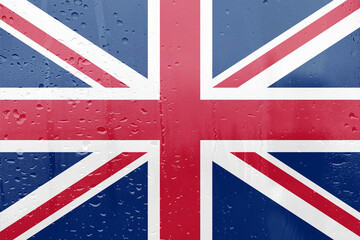 Fototapeta premium Union Jack flag on the wall representing the United Kingdom with red, white, and blue colors