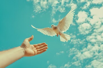 Fototapeta premium White Dove Taking Flight: A gentle hand reaches upward, offering a moment of peace and hope as a pristine white dove takes flight against a vibrant blue sky.
