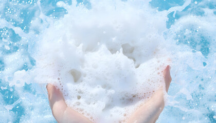 Hand holding soap foam in splashing water