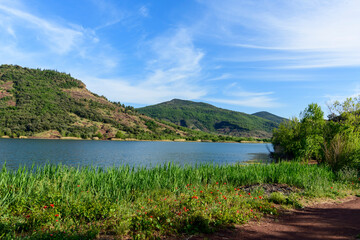 The banks of Lake Salagou in Europe, France, Occitanie, Herault, Clermont l Herault, in summer, on a sunny day.