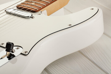 white electric guitar on wood background