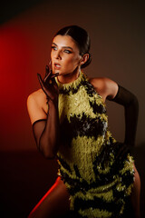 Woman performs sensual dance in smoke during a dark atmosphere with vibrant lighting effects