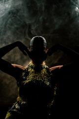 Dancing woman in smoke creates an enchanting atmosphere with passionate latin rhythms