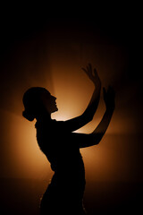 Dancer performs elegant latina movements in smoky atmosphere during a captivating evening show