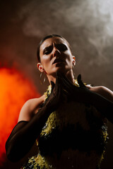 Dancing woman in dark smoke creates an atmospheric vibe with sensual movements in a passionate...
