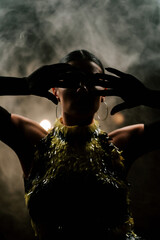 Dancer showcases sensual latina moves in a smoky atmosphere during a vibrant night performance