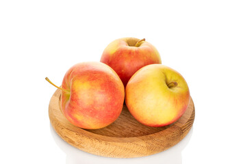 Three apples on a wooden tray isolated on a white background, close-up.