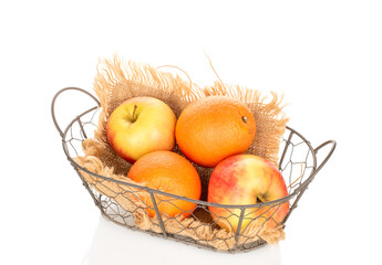 Two oranges and two apples in a basket isolated on a white background, close-up.