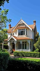 Serene Traditional House Surrounded by Lush Greenery and Blue Sky