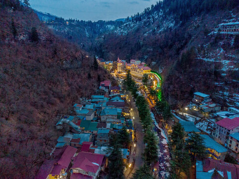 Aerial view on Borjomi park and and Borjomula river . at upper part - illuminated building odf some hotel(?)