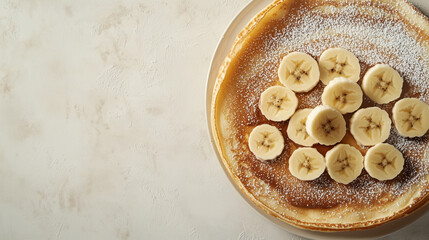 Crepes beautifully arranged with layers of Nutella, banana slices and dusted with powdered sugar.