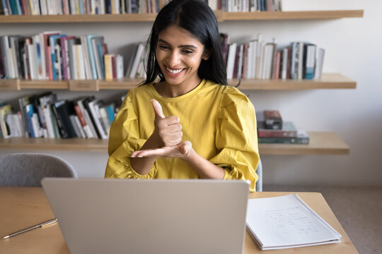 Inclusive communication. Friendly young female teacher tutor interpreter giving sign language lesson online communicate with pupil student having hearing disability by video call using hand gestures - Powered by Adobe