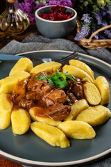 Beef stew in gravy served with potato dumplings.